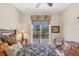 Bedroom with a ceiling fan, natural light, and golf course views at 2871 Royal Palm Dr, North Port, FL 34288
