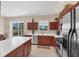 Bright kitchen with stainless steel appliances, breakfast bar, and sliding glass doors at 2871 Royal Palm Dr, North Port, FL 34288