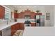 Well-lit kitchen featuring stainless steel appliances and ample counter space at 2871 Royal Palm Dr, North Port, FL 34288