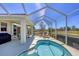 Inviting lanai with a relaxing spa, comfortable seating, and expansive outdoor views at 2871 Royal Palm Dr, North Port, FL 34288