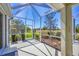 Well-kept screened lanai with views of manicured landscaping and the beautiful backyard area at 2871 Royal Palm Dr, North Port, FL 34288