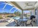 Inviting lanai with a soothing spa, dining area, lounge chairs, and serene outdoor views at 2871 Royal Palm Dr, North Port, FL 34288