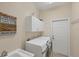 Functional laundry room with modern appliances, ample storage, and a convenient utility sink at 2871 Royal Palm Dr, North Port, FL 34288