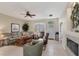This large living room offers tile flooring, a ceiling fan, and plenty of space for relaxing and entertaining at 2871 Royal Palm Dr, North Port, FL 34288