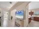 Open-concept living space with tile floors and access to kitchen and bathroom at 2871 Royal Palm Dr, North Port, FL 34288