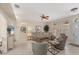 Bright living room with a comfortable seating area, tile floors, and a large window for natural light at 2871 Royal Palm Dr, North Port, FL 34288