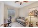 Bright office space with a comfortable sofa, desk, neutral decor, and a ceiling fan at 2871 Royal Palm Dr, North Port, FL 34288