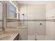Modern shower with glass enclosure, tile surround, and window for natural light at 2871 Royal Palm Dr, North Port, FL 34288