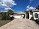 Beautiful, one-story home featuring a two-car garage, elegant arched entry and decorative driveway at 316 Orlando Blvd, Port Charlotte, FL 33954