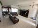Open living room featuring tile flooring, modern entertainment center and ceiling fan at 316 Orlando Blvd, Port Charlotte, FL 33954