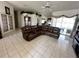 Open living room featuring tile flooring, large sectional couch and ceiling fan at 316 Orlando Blvd, Port Charlotte, FL 33954