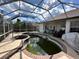 Screened-in pool area with a spa, with a view of backyard at 316 Orlando Blvd, Port Charlotte, FL 33954