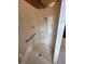 A tiled shower with a handheld shower head, bench, and grab bar at 316 Orlando Blvd, Port Charlotte, FL 33954