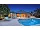 An amazing backyard features a covered patio, pool, outdoor seating and lush landscaping at 316 W Royal Flamingo Dr, Sarasota, FL 34236