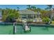Backyard with swimming pool and dock access with lush tropical landscaping at 316 W Royal Flamingo Dr, Sarasota, FL 34236