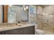 Elegant bathroom with double sink vanity, granite countertop, and glass door shower at 316 W Royal Flamingo Dr, Sarasota, FL 34236