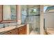 Bathroom with tile shower, granite counters, woven accents, and single sink vanity at 316 W Royal Flamingo Dr, Sarasota, FL 34236