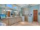 Bathroom with dual sinks, granite counters, large mirrors, and glass shower at 316 W Royal Flamingo Dr, Sarasota, FL 34236
