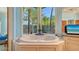 Large soaking tub with a bay window overlooking the tropical backyard at 316 W Royal Flamingo Dr, Sarasota, FL 34236