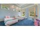 Bright bedroom with three twin beds, blue carpet and walls, and tray ceiling details at 316 W Royal Flamingo Dr, Sarasota, FL 34236