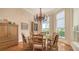 Dining room with hardwood floors, chandelier, and natural light from two windows at 316 W Royal Flamingo Dr, Sarasota, FL 34236