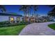 Beautiful home exterior with a winding paver driveway lined with manicured landscaping at 316 W Royal Flamingo Dr, Sarasota, FL 34236