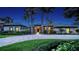 Stunning exterior view of a home with a paver driveway, lush landscaping, and elegant architectural design at 316 W Royal Flamingo Dr, Sarasota, FL 34236