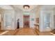 Elegant home foyer with a wood floor design, grand lighting, and sophisticated decor at 316 W Royal Flamingo Dr, Sarasota, FL 34236