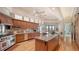 Bright kitchen features wood cabinetry, stainless steel appliances, granite counters, and an island at 316 W Royal Flamingo Dr, Sarasota, FL 34236