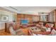 Elegant living room with wood paneled walls, fireplace, and comfortable seating arrangement exudes sophistication at 316 W Royal Flamingo Dr, Sarasota, FL 34236