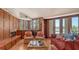 Inviting living room with a fireplace, wood paneling, and a water view at 316 W Royal Flamingo Dr, Sarasota, FL 34236