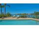Sparkling pool with waterfront views, lounge chairs, and lush landscaping at 316 W Royal Flamingo Dr, Sarasota, FL 34236