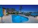 An inviting waterfront backyard features a shimmering pool, palm trees, lounge chairs and brick-paved patio at 316 W Royal Flamingo Dr, Sarasota, FL 34236