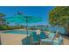 Inviting pool area with waterfront views, dining space, and comfortable lounge chairs for relaxing at 316 W Royal Flamingo Dr, Sarasota, FL 34236