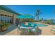 Backyard features a sparkling pool, outdoor seating, and lush landscaping creating a serene oasis at 316 W Royal Flamingo Dr, Sarasota, FL 34236