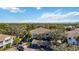Aerial view of a well-maintained community surrounded by mature trees and a nearby lake at 321 108Th W St # 120, Bradenton, FL 34209