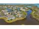 Stunning aerial view of waterfront condos surrounded by lush greenery and serene waterways in a picturesque community at 321 108Th W St # 120, Bradenton, FL 34209