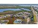 Stunning aerial view of waterfront community with pool, tennis courts, canals and mature trees at 321 108Th W St # 120, Bradenton, FL 34209