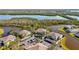 An aerial view showcases waterfront condos surrounded by canals, lush vegetation, and convenient covered parking at 321 108Th W St # 120, Bradenton, FL 34209