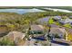 An aerial view features waterfront condos with lush vegetation, canals, and convenient covered parking at 321 108Th W St # 120, Bradenton, FL 34209