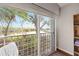 Scenic balcony showcasing lush landscaping, a serene lake view, and tropical palms at 321 108Th W St # 120, Bradenton, FL 34209