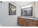 Bathroom featuring wood cabinets, granite countertop and updated mirror at 321 108Th W St # 120, Bradenton, FL 34209