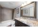 Updated bathroom featuring modern fixtures, a granite countertop, and a tiled shower at 321 108Th W St # 120, Bradenton, FL 34209