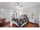 Bright bedroom featuring hardwood floors, ceiling fan, and balcony access for enjoying the view at 321 108Th W St # 120, Bradenton, FL 34209