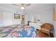 Comfortable bedroom includes hardwood floors, a ceiling fan, and a bright dresser at 321 108Th W St # 120, Bradenton, FL 34209