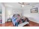 Inviting bedroom with hardwood floors, ceiling fan, and ample closet space for storage at 321 108Th W St # 120, Bradenton, FL 34209