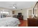 Bedroom featuring dresser, TV and sliding doors to balcony with outdoor seating at 321 108Th W St # 120, Bradenton, FL 34209