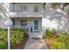 Picture perfect condo entrance with meticulous landscaping, outdoor seating, and a welcoming entrance at 321 108Th W St # 120, Bradenton, FL 34209