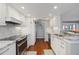 White updated kitchen with granite countertops and modern stainless appliances at 321 108Th W St # 120, Bradenton, FL 34209