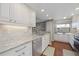 Modern kitchen with white cabinets, granite countertop, and stainless steel appliances at 321 108Th W St # 120, Bradenton, FL 34209